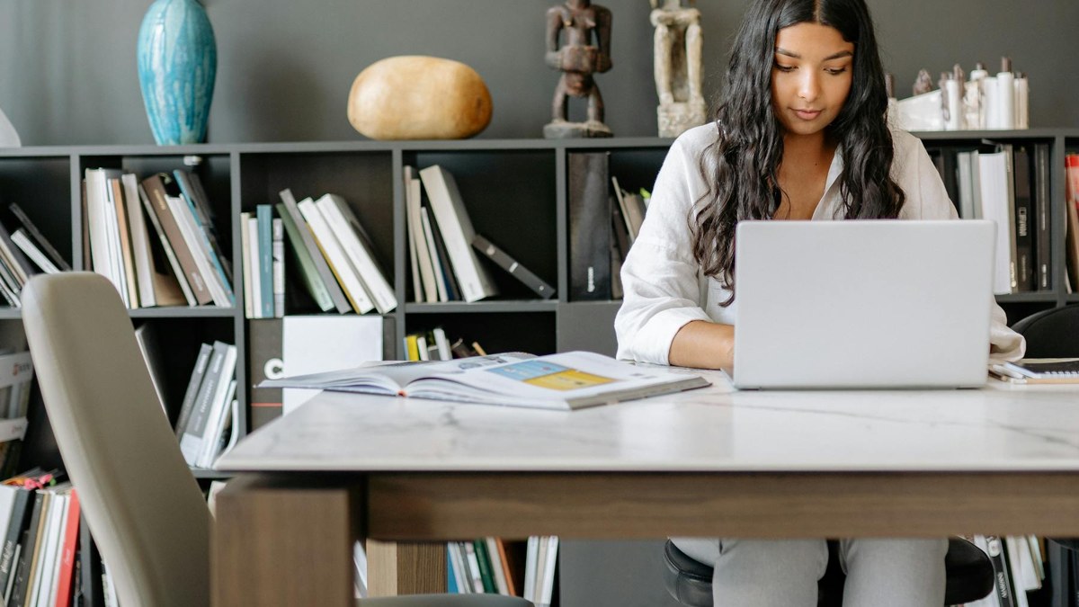 Profissional trabalhando em mesa administrativa com notebook